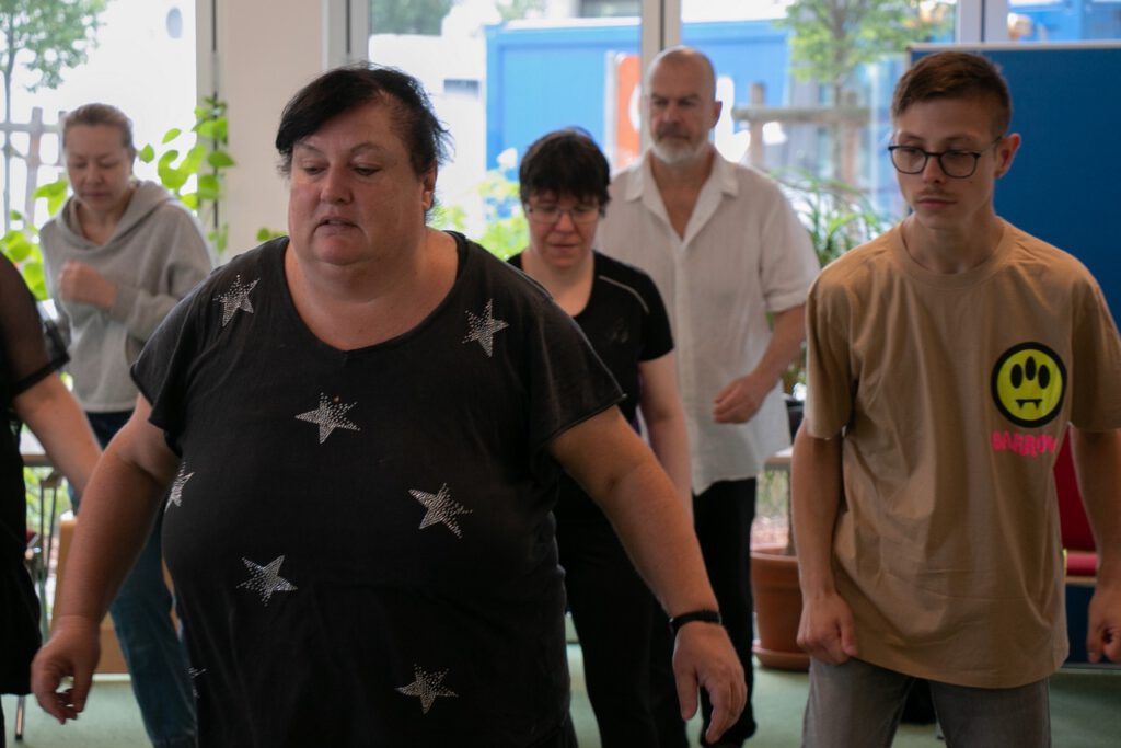 Drei Frauen und zwei Männer versuchen den Tanzschritten zu folgen.